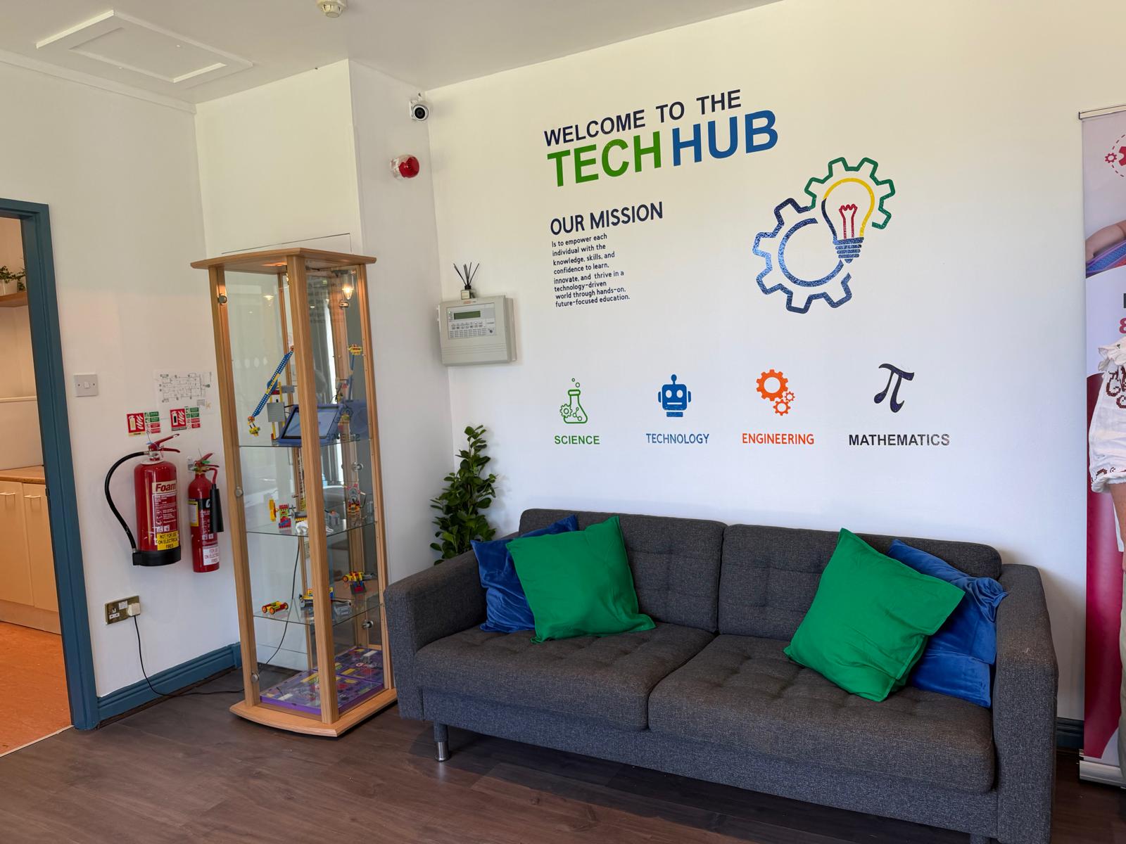 Real STEM Academy Ireland Tech Hub space with sofa, display cabinet and STEM wall graphics